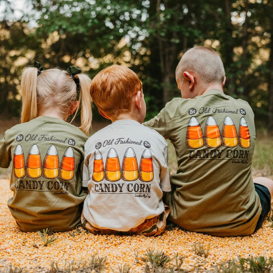 Three kids wearing Candy Corn tees outdoors